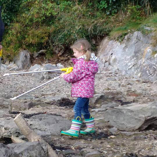 3. A young volunteer helping to clean the beaches 3. A young volunteer helping to clean the beaches